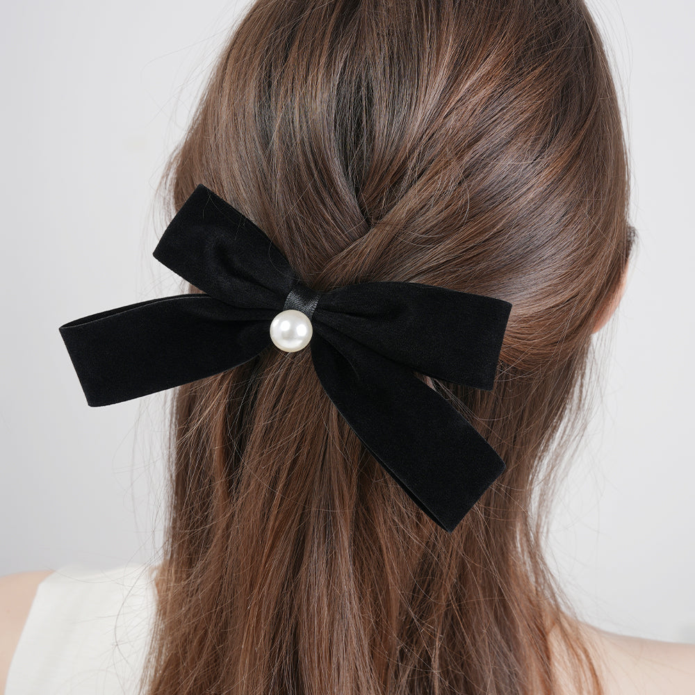 A French retro black velvet pearl bow with a hair clip at the back of the head