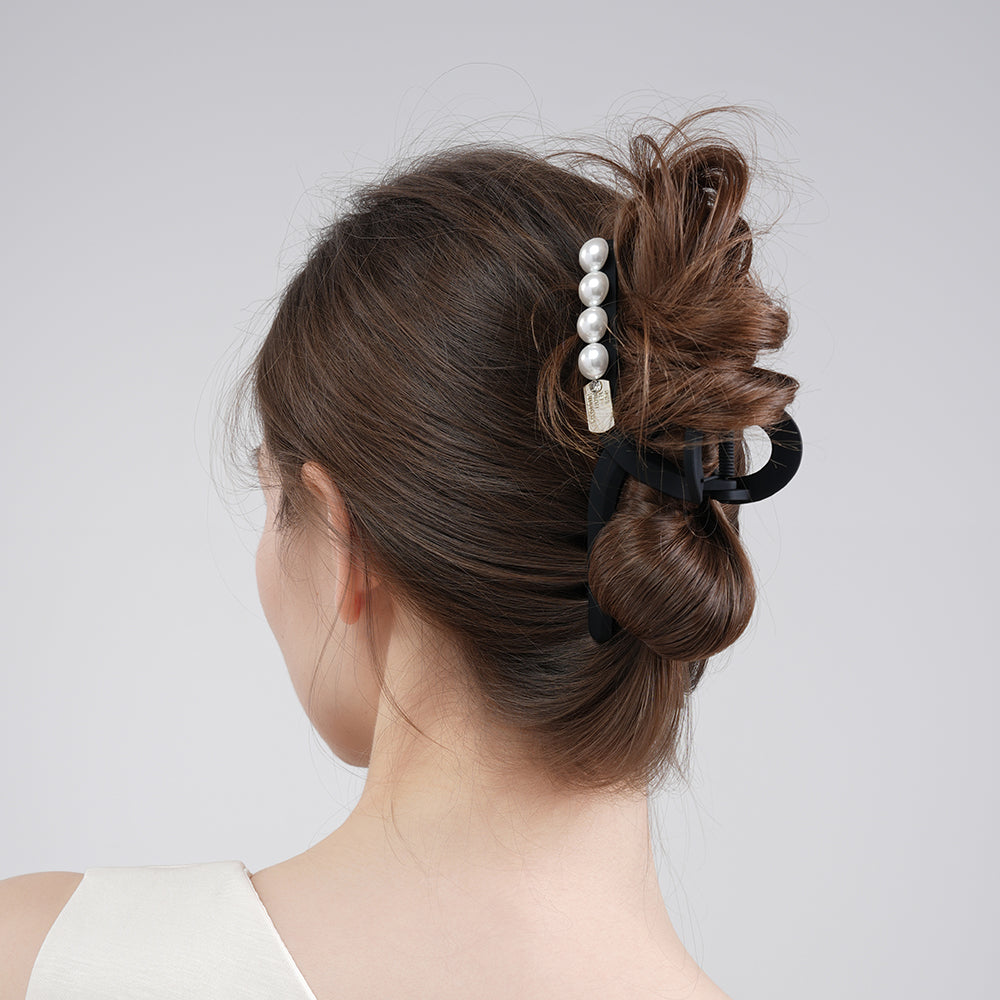 A sophisticated matte pearl hairpin with a high-end feel and a shark clip