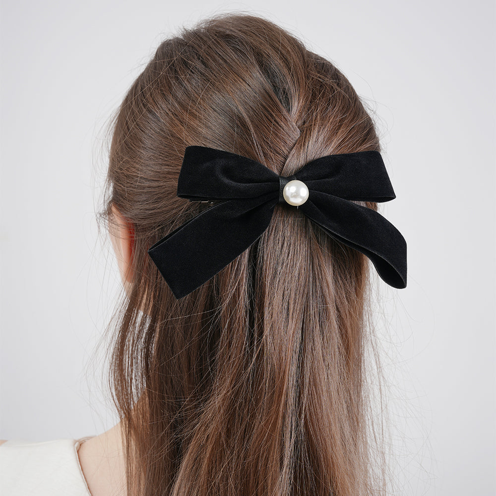 A French retro black velvet pearl bow with a hair clip at the back of the head