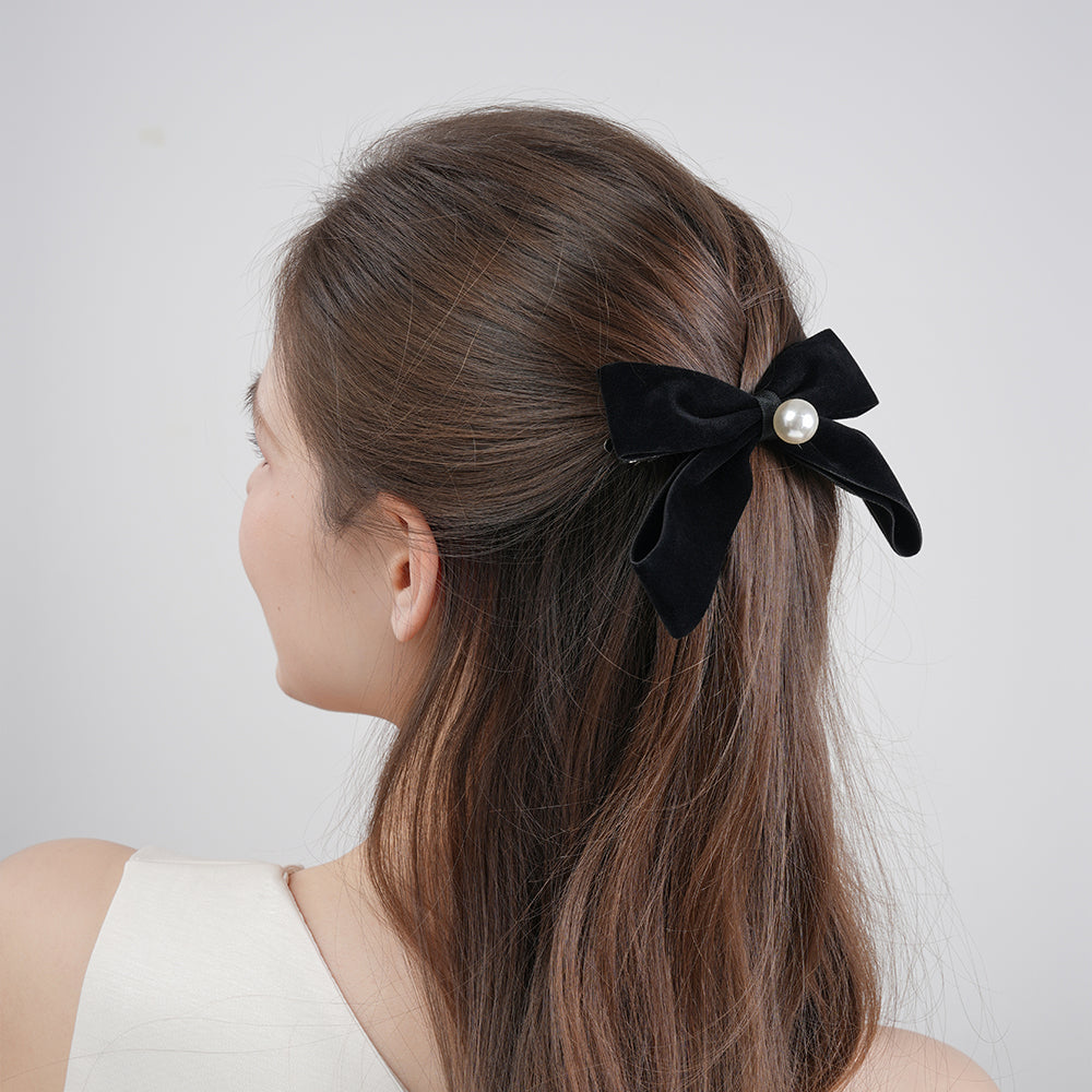 A French retro black velvet pearl bow with a hair clip at the back of the head
