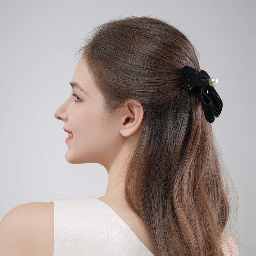 A French retro black velvet pearl bow with a hair clip at the back of the head